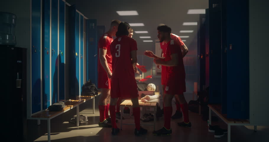 Football Players Form a Motivational Circle, Standing Shoulder to Shoulder, Holding Hands Together, Chanting and Cheering. Locker Room Fills with Team Spirit, Confidence and Brotherhood