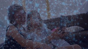 Sisters settling on sofa and reaching for smartphone, framing selfie and posing for social media. Friendship, lifestyle, casual, cheerful, relaxation, familial, candid - Powered by Shutterstock - Get 15% off with code: PIKWIZARD15