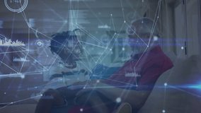 Grandson giving VR headset to grandfather pressing controller making swirling tech charts. Family, mentorship, innovation, interaction, connection, technology, relaxation - Powered by Shutterstock - Get 15% off with code: PIKWIZARD15