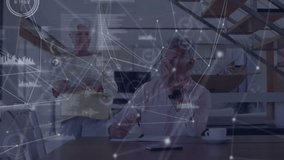 Senior man writing document initiating data charts overlay, woman placing coffee fueling tech work. Elderly, collaboration, digital, technology, home, support, activity - Powered by Shutterstock - Get 15% off with code: PIKWIZARD15