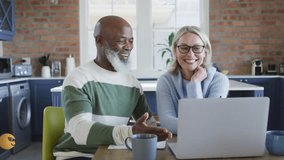 Couple reviewing finances on laptop triggers swirling 3D emoji overlay highlighting collaboration. Partnership, communication, innovation, technology, digital, teamwork, modern - Powered by Shutterstock - Get 15% off with code: PIKWIZARD15