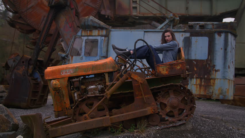 Old rusty tractor photoshoot in abandoned location during twilight hours