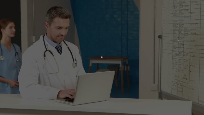 Doctor typing network graphics linking laptop schedule board as nurse pointing entries in hospital. Medical, healthcare, digital, technology, teamwork, collaboration, modern - Powered by Shutterstock - Get 15% off with code: PIKWIZARD15