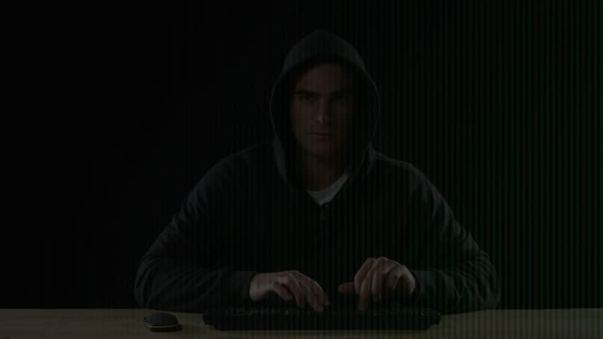 Hooded man typing on keys launching terminal boosting green overlay while monitoring security logs. Technology, cybersecurity, programming, coding, digital, data, innovation
