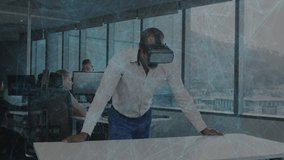Mature man putting on VR headset, revealing encrypted overlay over office table while peer entering. Technology, collaboration, innovation, digital, communication, futuristic, professional - Powered by Shutterstock - Get 15% off with code: PIKWIZARD15