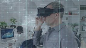 Mature adult man slipping VR headset in office activating finance data grid overlay for analysis. Technology, innovation, collaboration, digital, corporate, futuristic, data - Powered by Shutterstock - Get 15% off with code: PIKWIZARD15