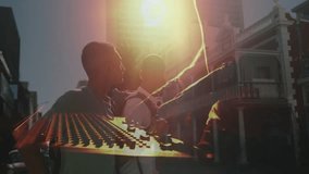 DJ sliding fader syncing mixer with guitarist strumming chord under lens flare for music production. Music, collaboration, urban, vibrant, dynamic, performance, entertainment - Powered by Shutterstock - Get 15% off with code: PIKWIZARD15