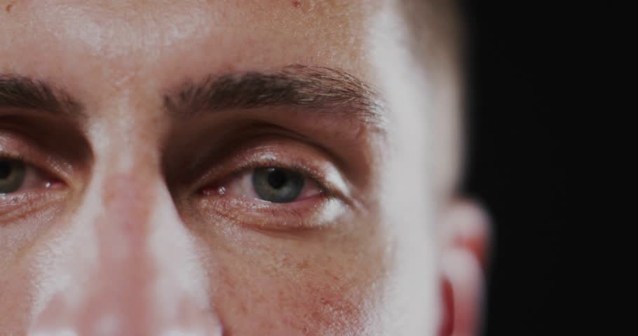 Mid adult man holding gaze activating lightning overlay pulsing across brow and cheek in tech demo. Futuristic, biotechnology, neural, digital, innovation, visual effects, cinematic