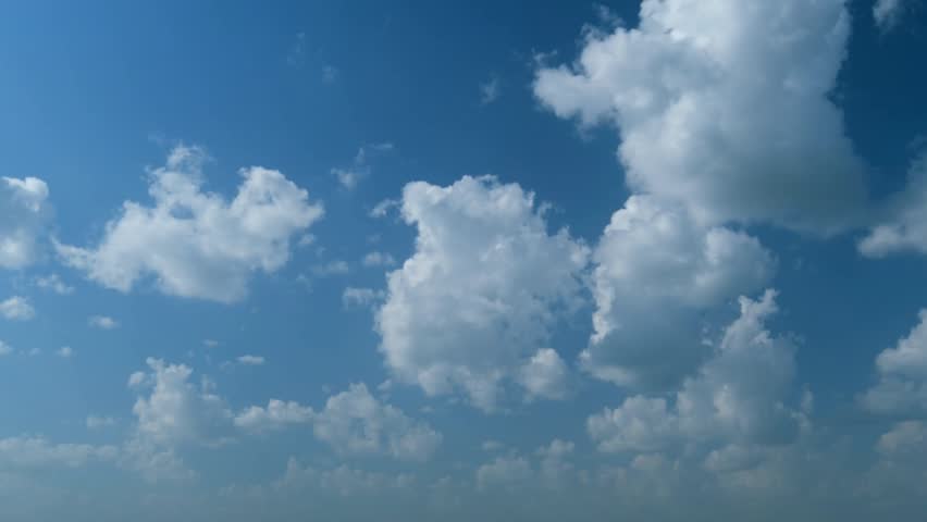 Stunning blue sky with drifting clouds, perfect for background visuals, weather videos, and cinematic scenes.