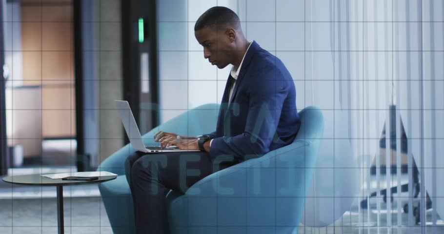 Businessman typing on laptop in blue lounge chair activating cybersecurity graphics around laptop. Professional, technology, cybersecurity, innovation, corporate, secure, modern