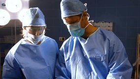 Female surgeon glancing raising hand adjusting top coordinating surgery as digital wave flowing. Medical, teamwork, futuristic, clinical, technology, healthcare, precision - Powered by Shutterstock - Get 15% off with code: PIKWIZARD15