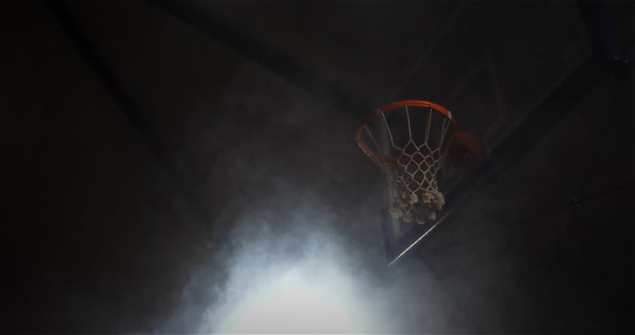 Player raising ball and dunking while animated lines lighting rim and fog pulsing for sports promo. Dynamic, athletic, urban, dramatic, monochrome, futuristic, energetic