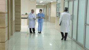 Hospital, healthcare, medical, doctor, nurse using tablet to review patient information, senior male mentoring young student trinee in hallway, technology helps improve teamwork efficiency diagnosis - Powered by Shutterstock - Get 15% off with code: PIKWIZARD15