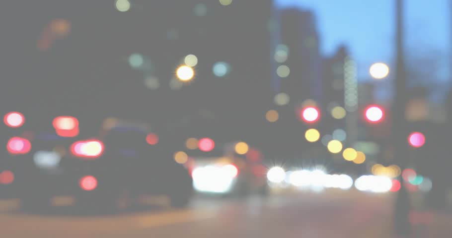 At fourth second hands gripping film camera adjusting focus ring and shutter capturing dusk bokeh. Vintage, aperture, bokeh, urban, cinematic, nostalgic, artistic