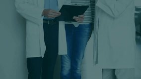 Two doctors consulting patient with animated trend lines sweeping tablet, doctor tapping. Medical, professional, digital, data, analytic, consultation, healthcare - Powered by Shutterstock - Get 15% off with code: PIKWIZARD15