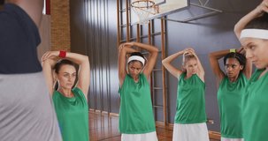 Coach guiding players into sports stretch while world map and network nodes expanding overhead. Athletes, training, futuristic, technology, fitness, teamwork, innovation - Powered by Shutterstock - Get 15% off with code: PIKWIZARD15