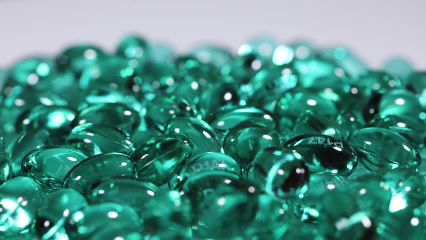 Blue green pill capsules isolated, analgesic pile, painkiller drugs, sedative pills group, medicine gel capsules on white background.