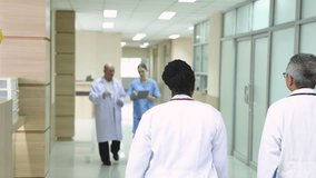 Hospital, healthcare, medical, doctor, nurse using tablet to review patient information, senior male mentoring young student trinee in hallway, technology helps improve teamwork efficiency diagnosis - Powered by Shutterstock - Get 15% off with code: PIKWIZARD15