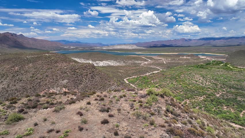Aerial view of Horseshoe Reservoir showing the arid landscape, with winding roads and mountains meeting the blue waters, Horseshoe Reservoir, Arizona, United States.