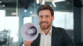 Excited businessman in a suit and white shirt triumphantly announces financial success. Confident male holds megaphone and cash in a modern office, celebrating profit and wealth. - Powered by Shutterstock - Get 15% off with code: PIKWIZARD15