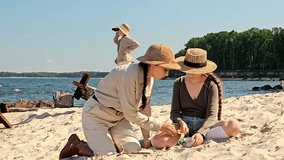 A mother and children traveling to the sea, vacationing with children in nature, searching for something in the sand and looking through a magnifying glass, exploring fossils in the sand - Powered by Shutterstock - Get 15% off with code: PIKWIZARD15