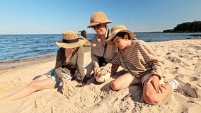 A mother and children traveling to the sea, vacationing with children in nature, searching for something in the sand and looking through a magnifying glass, exploring fossils in the sand - Powered by Shutterstock - Get 15% off with code: PIKWIZARD15