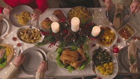 Friends Family Members Enjoy Christmas Turkey Dinner, Spending Holiday Season Together. Festive Evening Atmosphere, Decorations with Christmas at Home. thanksgiving. Cooking food. Plates dishes. hand - Powered by Shutterstock - Get 15% off with code: PIKWIZARD15