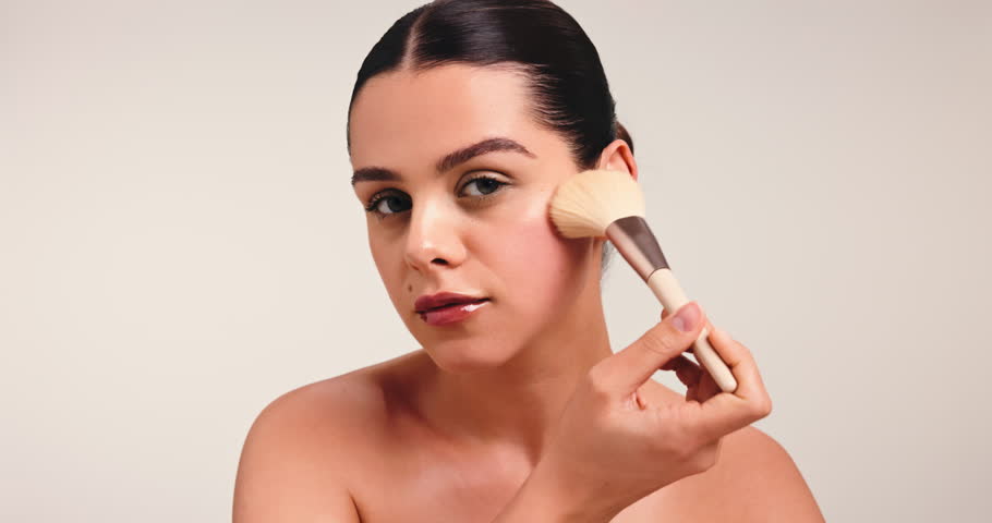 Blush, makeup brush and beauty with face of woman in studio for cosmetic, glow and aesthetic. Self care, foundation and space with person on white background for luxury, cosmetology and makeover tool