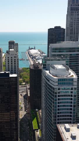Chicago USA, Vertical Drone Shot of Navy Pier and Lake Michigan Behind Apartment Buildings and Towers