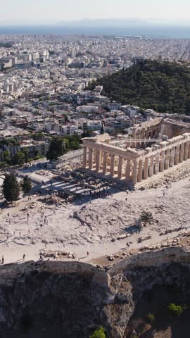 Approaching the Acropolis in Athens, Greece, with panoramic views of the surrounding city in the background. Vertical Aerial