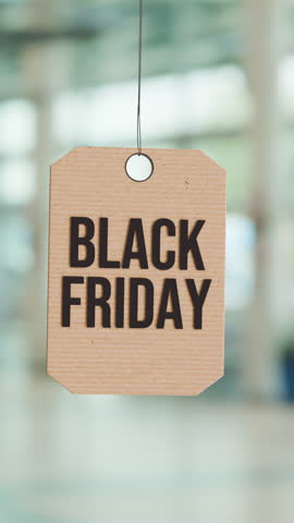 Black Friday Sale Tag Swinging in Modern Retail Space With Bright Background