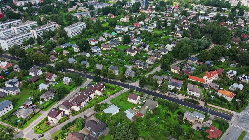 Green suburban residential area near the city, Darzciems neighborhood of Riga, aerial orbital