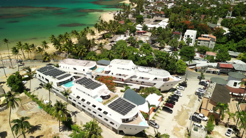 Aerial panorama of Las Terrenas — vibrant coastal city with tropical shoreline, ocean horizon, and green palms. Great for travel promos and destination showcases