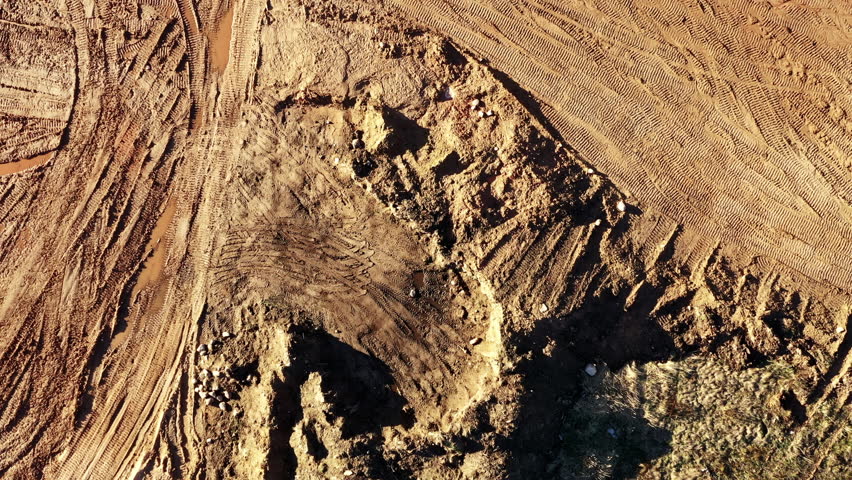 Aerial View of Orange Mud Tracks and Quarry Patterns With Heavy Machinery Traces