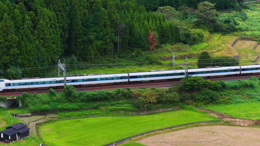 Japanese Train Passing Countryside Farms and Small Rural Town in Shiga, Japan