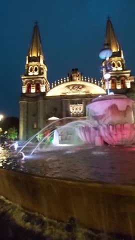 Night view of the Guadalajara Cathedral with artificial lighting on a cloudy day. Guadalajara Cathedral, Jalisco, Mexico. Famous main Catholic temple, attraction, and monument. 9x16 Format Aspect