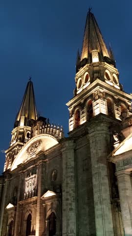 Night view of the Guadalajara Cathedral with artificial lighting on a cloudy day. Guadalajara Cathedral, Jalisco, Mexico. Famous main Catholic temple, attraction, and monument. 9x16 Format Aspect