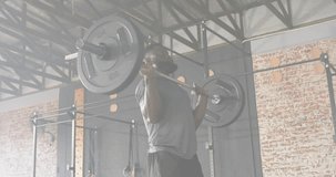 Man steadying barbell in gym activating package network for logistics technology via animated icons. Fitness, technology, connectivity, strength, innovation, health, digital - Powered by Shutterstock - Get 15% off with code: PIKWIZARD15