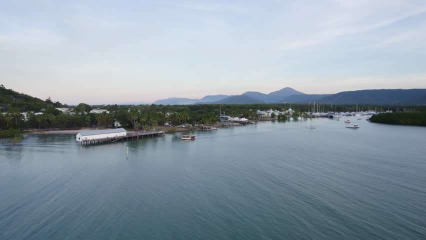 Aerial view orbiting boat leaving Port Douglas, sunrise, Australia