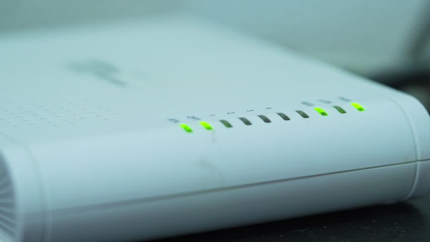 Close up Shot of Blinking Lights on White Internet Modem