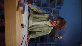 Architectural Planning. Focused Professional Man Reviews Large Blueprints in Vertical Video Format. Concept of Architecture, Engineering, Technical Design, and the Demands of Complex Projects. - Powered by Shutterstock - Get 15% off with code: PIKWIZARD15