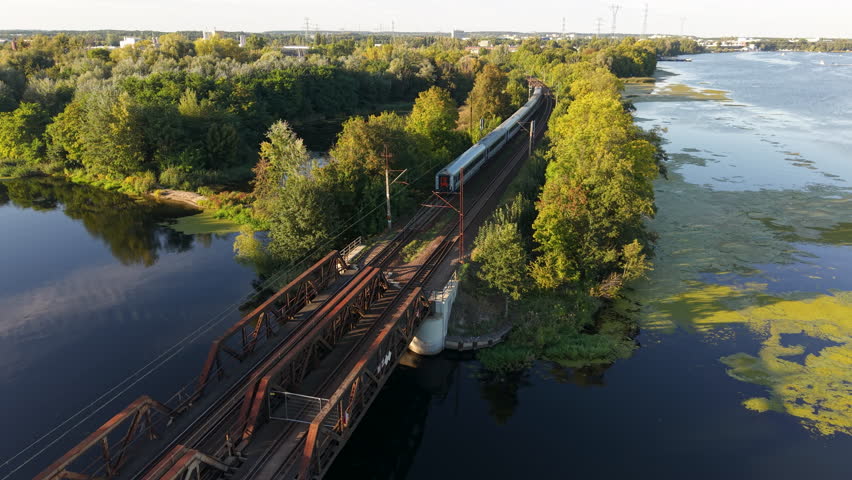 BYDGOSZCZ, POLAND - 28 SEP 2025: Aerial Bydgoszcz Poland Brda River follow train. Historic population center. River Brda inland waterway, tributary of Vistula. Historical trade and transportation.