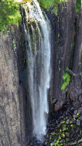 Majestic aerial view of the stunning waterfall on the isle of Skye Scotland surrounded by dramatic cliffs and lush greenery