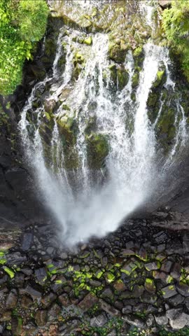 Breathtaking aerial view of a stunning waterfall on the isle of Skye in Scotland surrounded by lush greenery