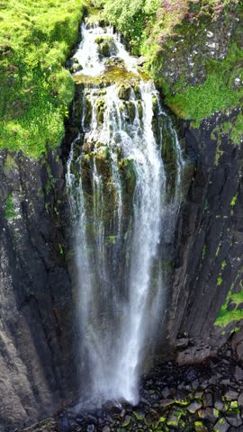 Breathtaking aerial view of a stunning waterfall on the enchanting Isle of Skye in Scotland