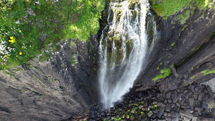 Majestic aerial view of a stunning waterfall in the enchanting Isle of Skye Scotland