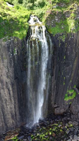 Majestic waterfall cascades down rocky cliffs on the Isle of Skye in Scotland showcasing nature