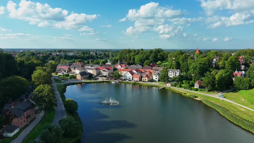 Scenic Fountain Over Lake Talsi And Coastal Town In Talsi, Latvia. Aerial Drone Shot