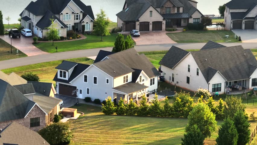 Aerial view of upscale American suburban neighborhood with large modern houses near a peaceful lake, showing residential lifestyle and waterfront living in USA. Peaceful noble housing area theme.