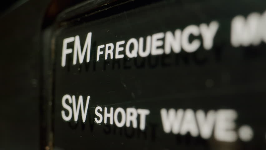 Retro radio tape recorder, audio cassette close-up. Listening to music, old radio boom box player, macro of vintage music listening. 